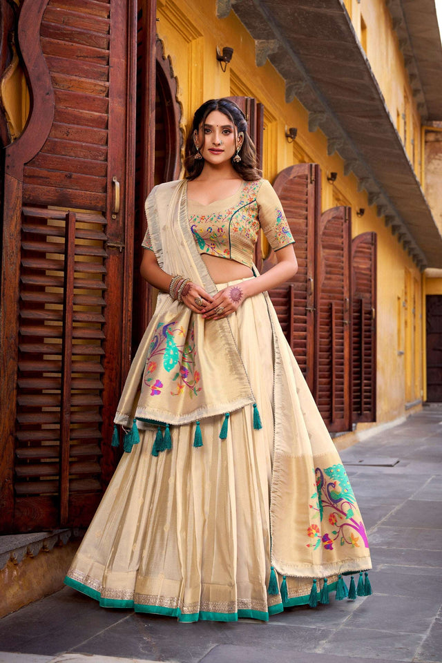 Cream lehenga choli with floral embroidery, green tassel-edged dupatta