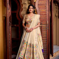 Cream lehenga choli with multicolor floral print, matching dupatta, blue tassel hem
