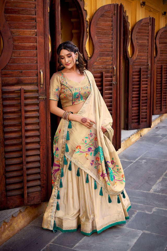 Cream lehenga choli with colorful tassel trim and floral border dupatta