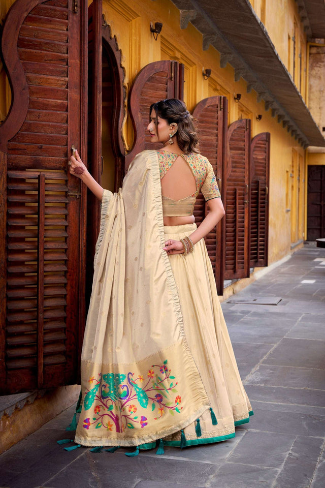 Cream lehenga choli with green border and floral backless blouse, dupatta drape