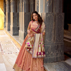 Peach lehenga choli set with gold zari work, wide border, and magenta patterned dupatta