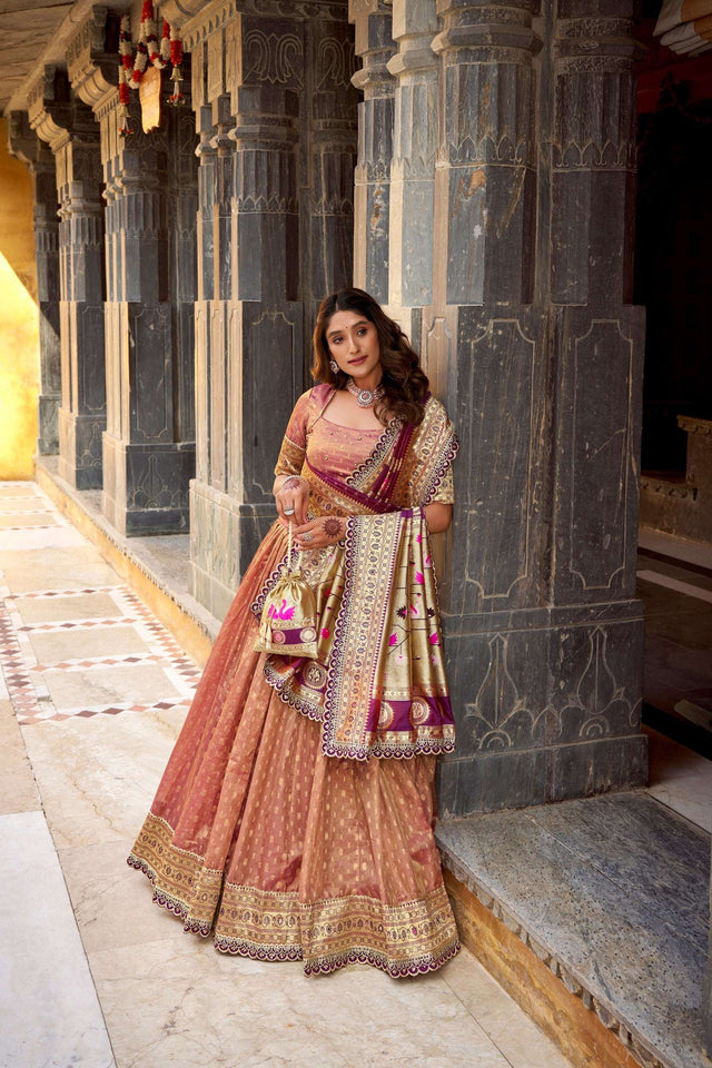 Peach lehenga choli set with gold zari work, wide border, and magenta patterned dupatta