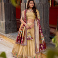 Gold lehenga choli set with purple zari border, multicolor motifs, and matching dupatta