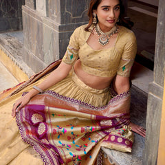 Gold lehenga with embellished blouse and draped purple dupatta, multicolor thread motifs