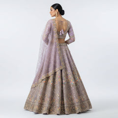 Embroidered lilac lehenga set with open-back blouse and gold floral lehenga skirt
