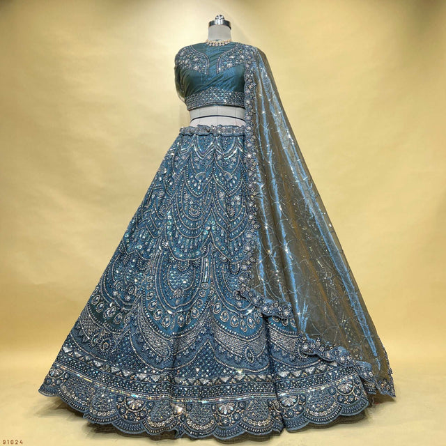 Back view of blue embroidered lehenga with full skirt flare and sheer dupatta