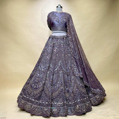 Embroidered deep purple lehenga with flared skirt, sequin bodice and long sheer net dupatta