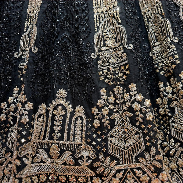 Close-up of black net lehenga: antique gold jharokha arches, flowering urns and vine sprays