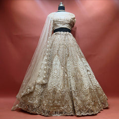 Ivory net lehenga with antique gold cutdana and pearl embroidery, scalloped hem and net dupatta