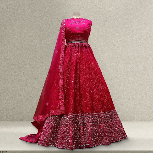 Pink sequined lehenga with embroidered bodice, flared skirt, and matching sheer dupatta.