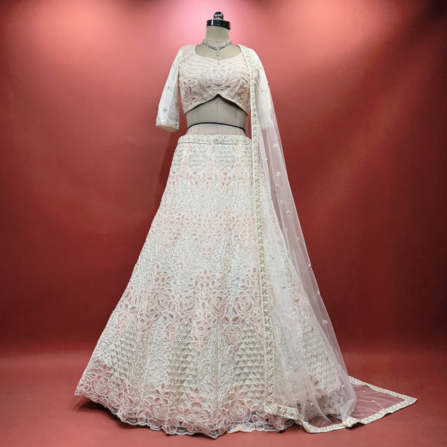 Pearl white beaded lehenga set with short sleeves, matching top and flowing skirt