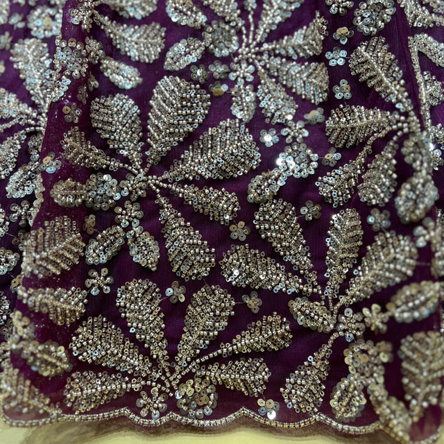 Wine-purple beaded fabric with dense silver embroidery and floral motifs