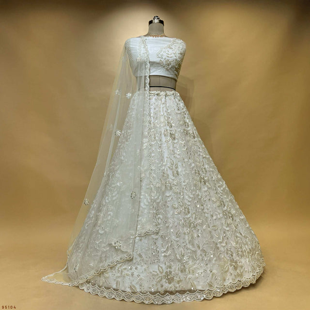 Off-white designer lehenga with embroidered bodice and full flared skirt