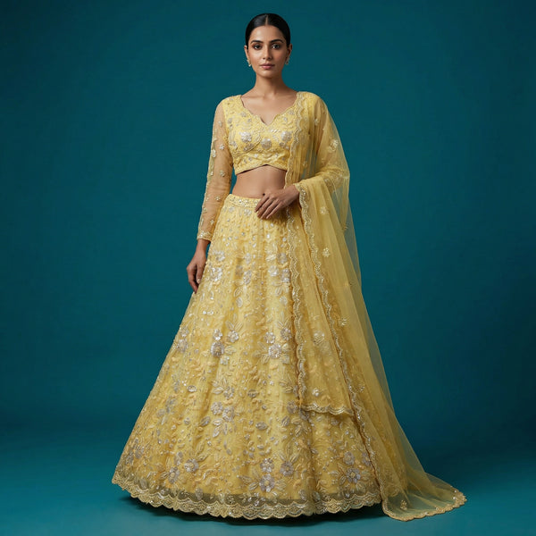 Yellow embroidered lehenga set with crop blouse and matching sheer dupatta