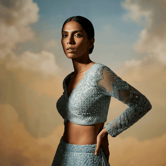 Powder blue sequined crop blouse and lehenga with long beaded sleeves