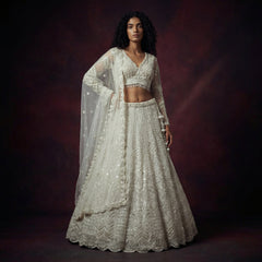 Off-white embellished lehenga set with V-neck blouse and long flared skirt