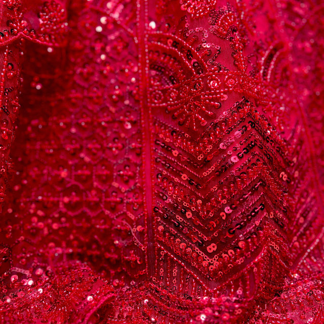 Red sequin and beadwork detail with embroidered geometric pattern on lehenga fabric
