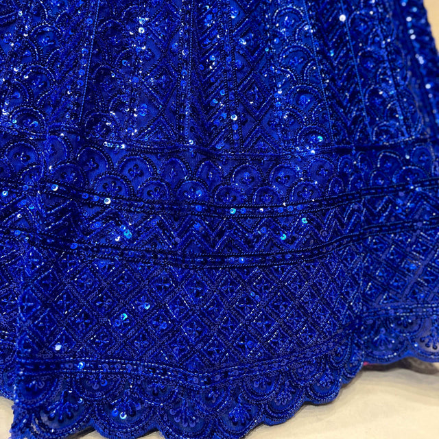 Royal blue beaded embroidery on lehenga hem with ornate scalloped border