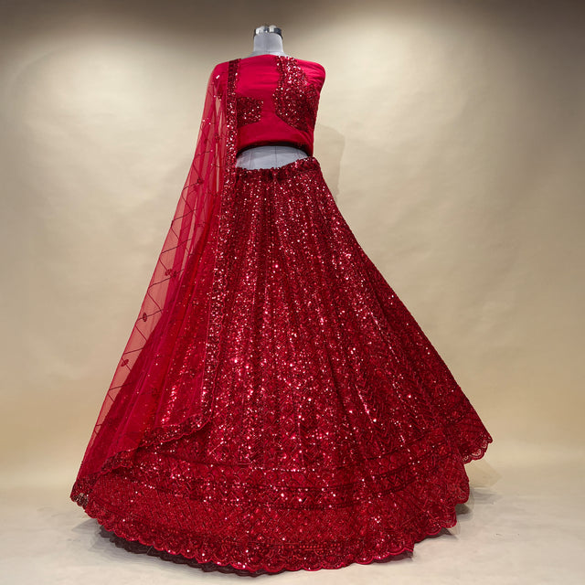 Red sequined lehenga with sheer draped sleeves and full flared skirt