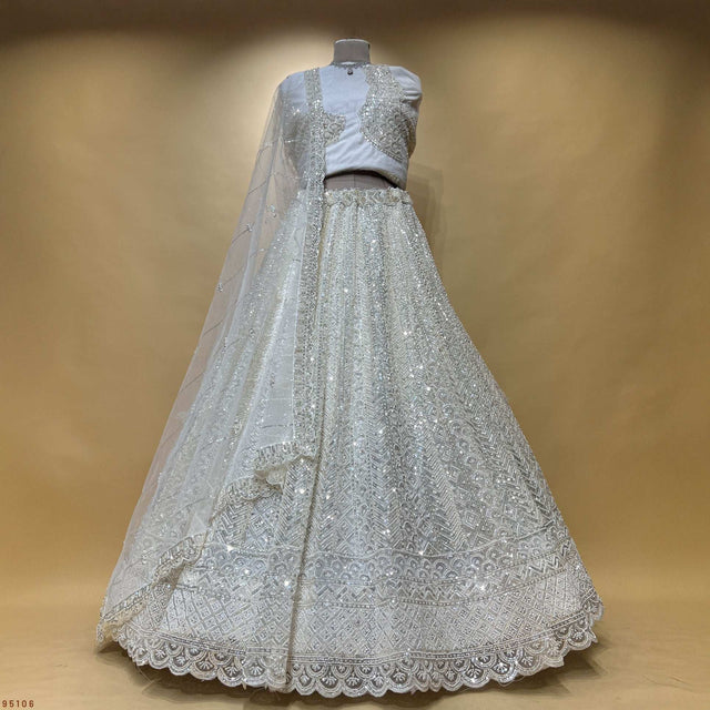 Off-white beaded lehenga with sheer dupatta and scalloped lace hem
