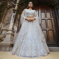 Off-white handworked lehenga choli with lace detailing, long sleeves, flared skirt