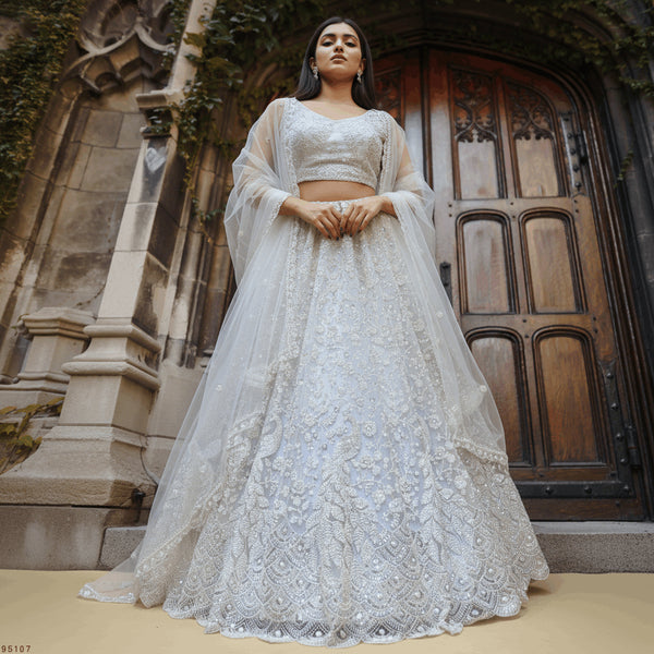 Off-white embroidered lehenga choli set, long-sleeve crop top and flared skirt