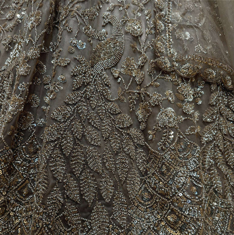 Close-up of champagne gold bead and sequin embroidery on lehenga fabric