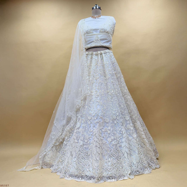 Off-white lehenga choli with fitted blouse, embellished skirt, and matching sheer dupatta