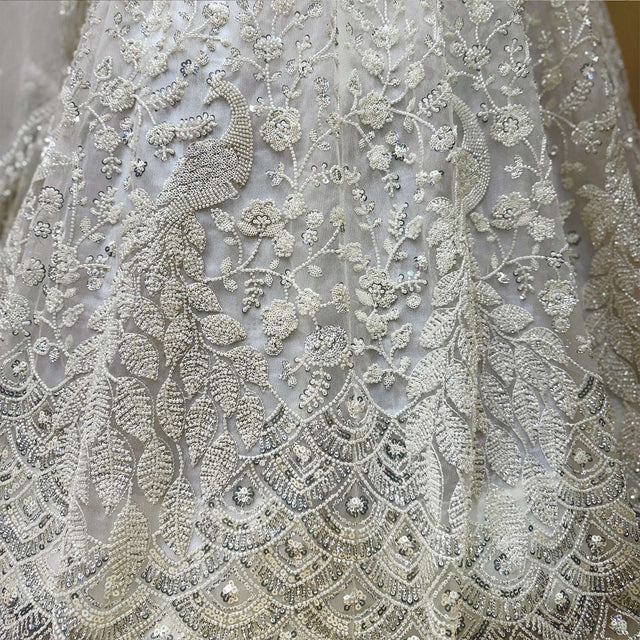 Close-up of off-white floral beadwork on lehenga choli fabric