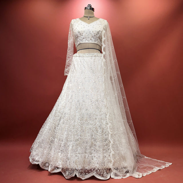 White lehenga set with embroidered bodice and sheer lace dupatta