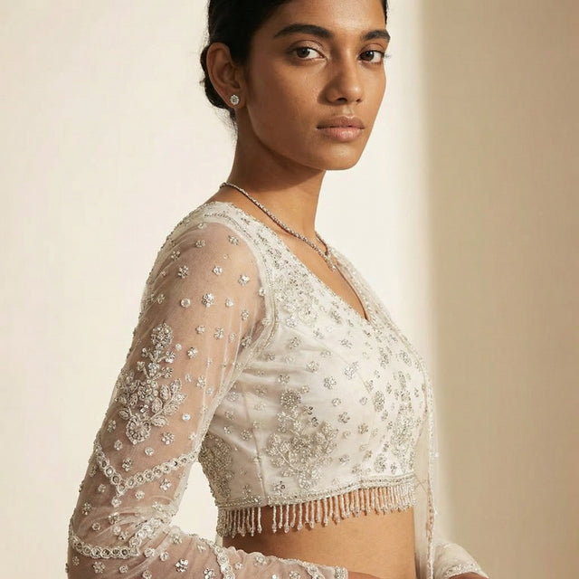 Embroidered sheer blouse sleeve with cutdana-like beadwork and tassel trim