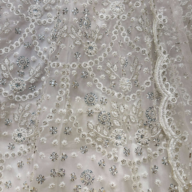 White bead and sequin embroidery pattern on sheer mesh fabric, scattered motifs