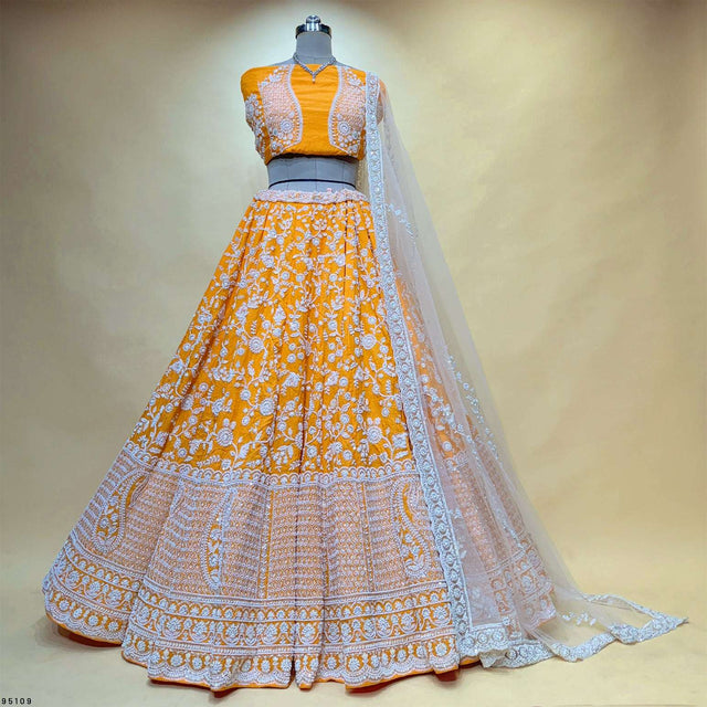 Orange lehenga with silver floral embroidery, short blouse, and sheer dupatta