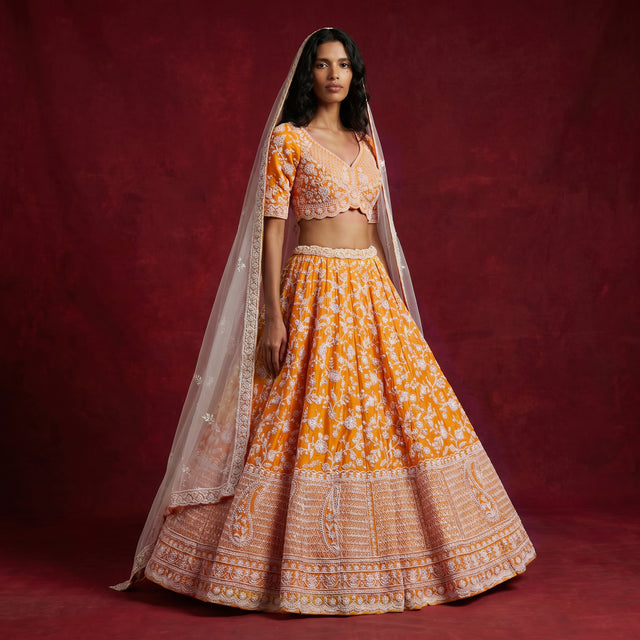 Orange embroidered lehenga skirt with matching full-sleeve blouse and sheer dupatta