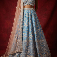 Embroidered azure blue lehenga skirt with gold-toned border and matching sheer dupatta