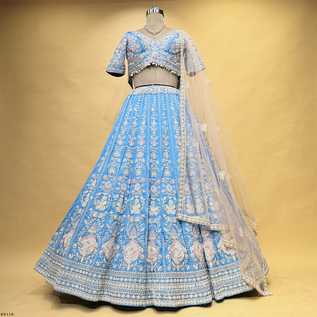 Beaded blue lehenga set on mannequin with short-sleeve blouse, full flared skirt, sheer dupatta