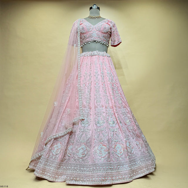 Pink lehenga with ornate bead embroidery, V-neck blouse, full skirt and sheer net dupatta