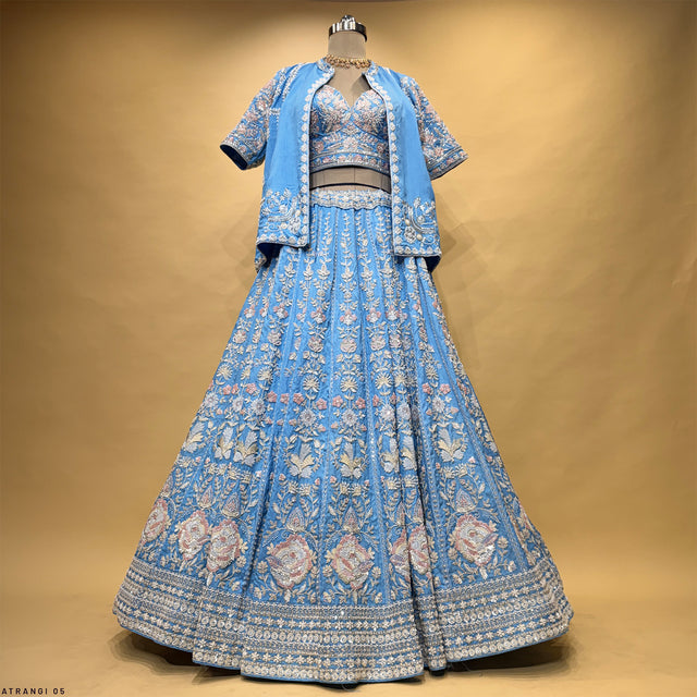 Blue embroidered lehenga with flared skirt and jacket-style blouse with short sleeves