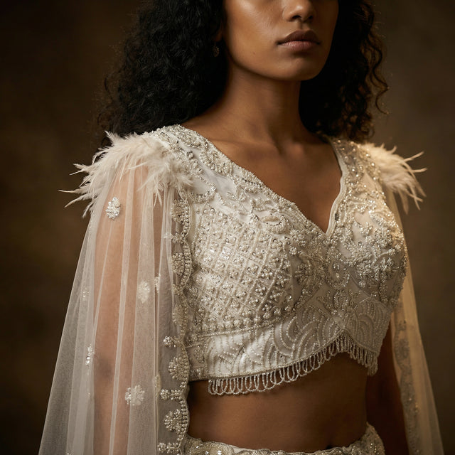 Off-white embellished net blouse with cape sleeves and V neckline