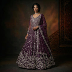 Wine purple party gown with silver embroidery, long sleeves, draped cape detail.