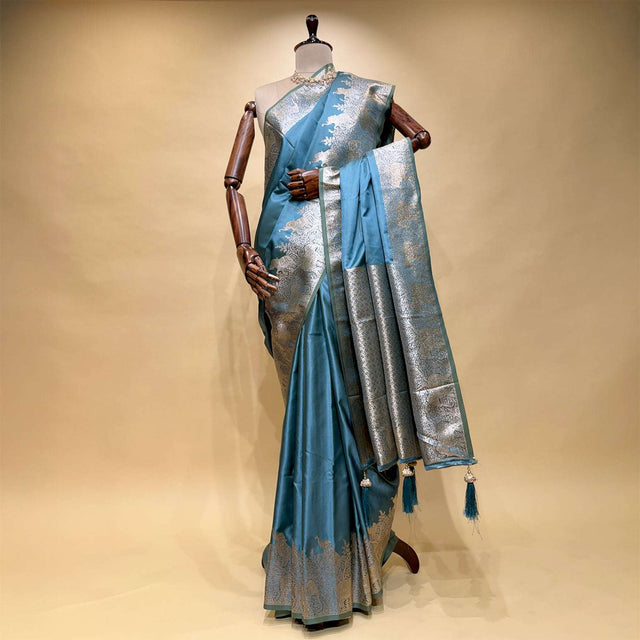 Teal satin silk saree with silver zari border, elephant pallu and tassels