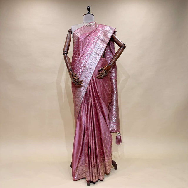 Rose gold satin silk saree on mannequin with zari border pallu and floral pattern