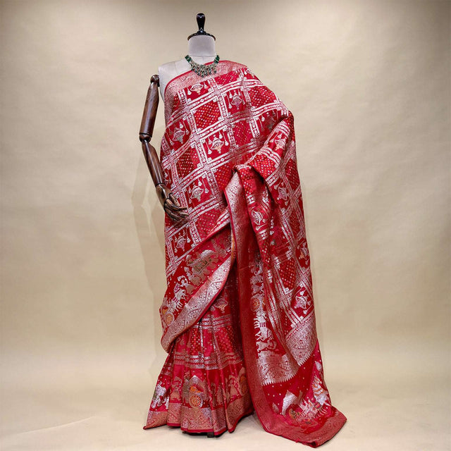 Rani pink satin silk saree with zari-patterned pallu and ornate border, full drape