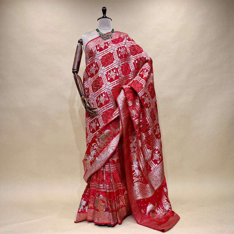 Rani pink satin silk saree with zari-patterned pallu and ornate border, full drape
