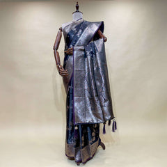 Navy satin silk saree on mannequin with silver zari border, patterned pallu and tassel fringe