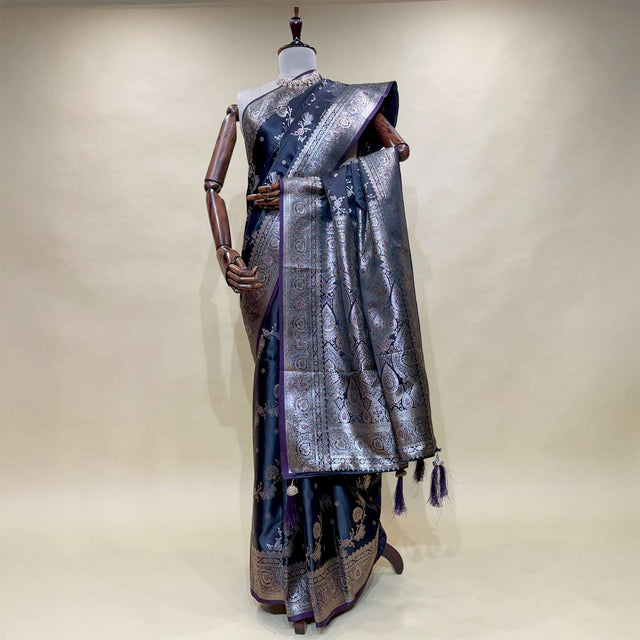 Navy satin silk saree on mannequin with silver zari border, patterned pallu and tassel fringe