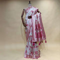 Patola-style silk saree with pink/off-white geometric motifs and magenta border tassels