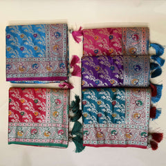 Folded leheriya-style silk sarees with contrast borders, blue and purple floral motifs