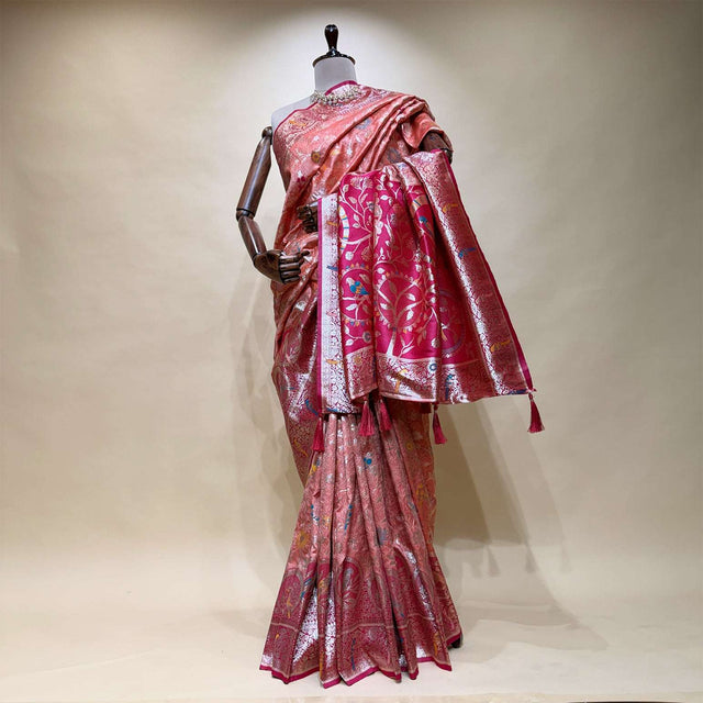 Pink silk saree with parrot motif, contrasting border and pallu, draped on mannequin