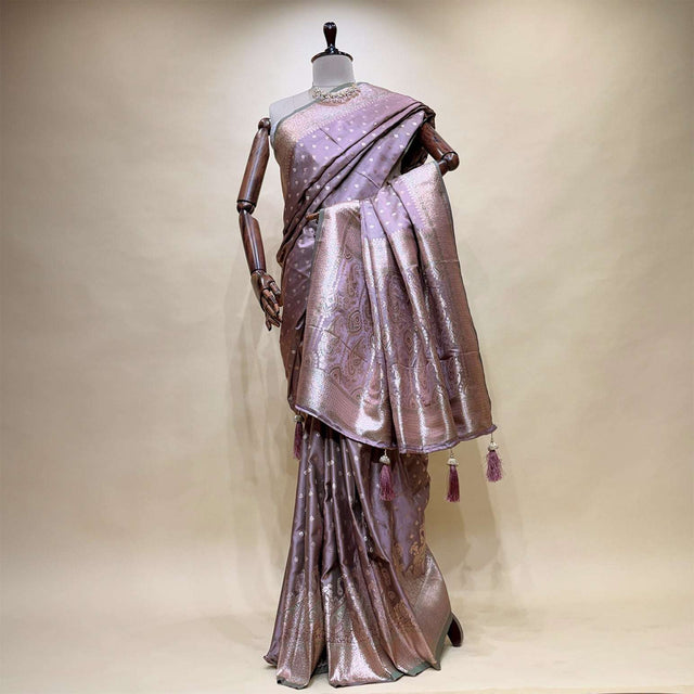 Lavender satin silk saree with zari border pallu and blouse, draped on mannequin